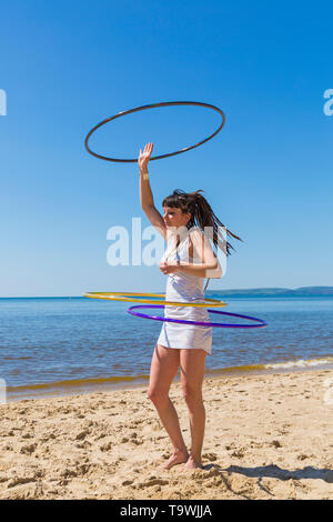 Southbourne, Bournemouth, Dorset, UK. 21st May, 2019. UK weather: lovely warm sunny morning as Lottie Lucid performs her hula hooping routine on the beach at Southbourne, enjoying the warm sunny weather in her mini dress. Credit: Carolyn Jenkins/Alamy Live News