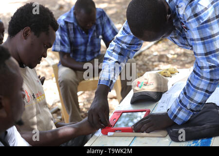Kipcherere, Bariongo, Kenya. 20th May, 2019. An Officer from the National Integrated Identity Management system (NIIMS) seen helping Mr. Charles Chepkwony process his biometric data during Kenya's nationwide campaign seeking to Marge personal information into single electronic document called ''˜Huduma Namba'.The 45-day registration started on April and ended on 18 May 2019, but country's President Uhuru Kenyatta extended the exercise to 25 May 2019. Credit: Billy Mutai/SOPA Images/ZUMA Wire/Alamy Live News Stock Photo