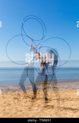 Southbourne, Bournemouth, Dorset, UK. 21st May 2019. UK weather: lovely warm sunny morning as Lottie Lucid performs her hula hooping routine on the beach at Southbourne, enjoying the warm sunny weather - multiple exposure. Credit: Carolyn Jenkins/Alamy Live News