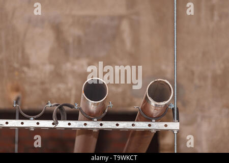 Pipes in the basement on the background of a concrete wall. Stock Photo