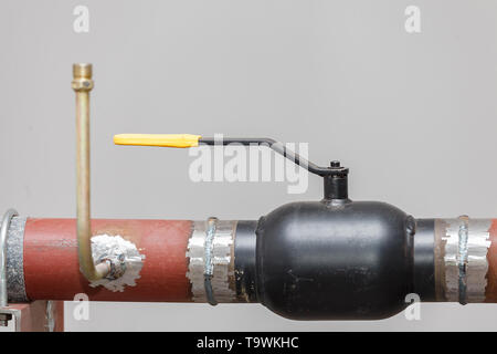 A heating system unit against a gray wall. Stock Photo