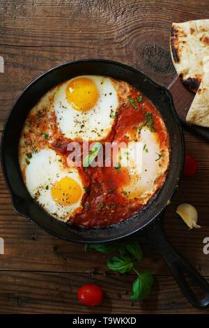 Homemade Shakshouka - Middle Eastern breakfast Eggs poached in spicy tomato sauce Stock Photo