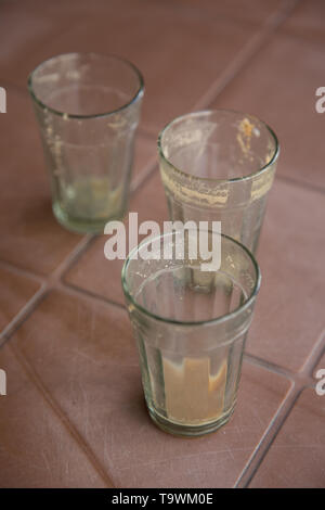 Three empty tea glasses on plastic table Stock Photo