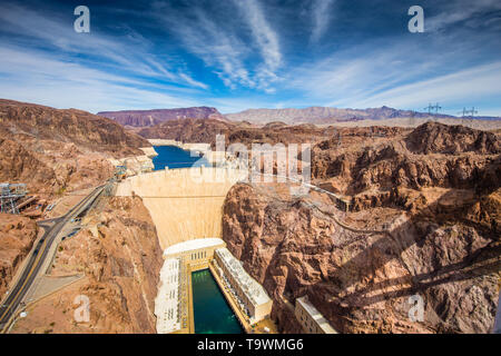 Aerial wide angle view of famous Hoover Dam, a major tourist attraction located on the border between the states of Nevada and Arizona, on a beautiful Stock Photo