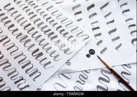 Letters train background and calligraphy pen paper. Learning calligraphy Stock Photo