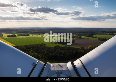 Agricultural landscape seen from the top of a wind turbine between the rotor blades Stock Photo