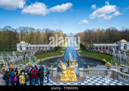 Saint Petersburg, Russia - May 2019: Peterhof fountains and palace view and tourists visiting. The Peterhof Palace is a popular spot for sightseeing. Stock Photo