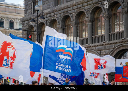 Saint Petersburg - May 2019: United Russia flag in political parade in Russia.   United Russia is the ruling political party of the Russian Federation Stock Photo