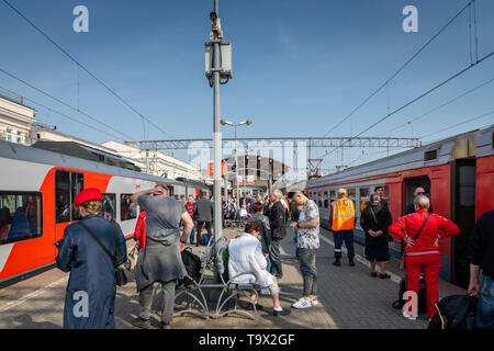 Moscow, Russia - May 2019: Russian Railways high speed train and passengers on the platform of Kursky railway in Moscow. Stock Photo