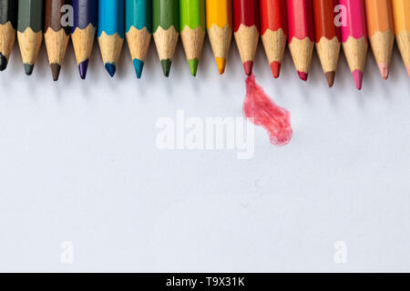 Set of colored pencils in rainbow colors wait for their first picture with a pupil, student or drawer as crayon with blue, red and yellow Stock Photo
