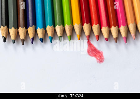 Set of colored pencils in rainbow colors wait for their first picture with a pupil, student or drawer as crayon with blue, red and yellow Stock Photo