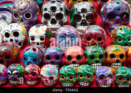 Mexico souvenir - colourful painted porcelain skulls for sale on a market stall, Yucatan, Mexico Latin America - Stock Photo