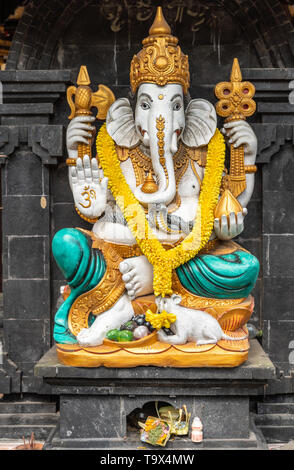 Bali, Indonesia - February 25, 2019: Ulun Danu Beratan Temple in Bedoegoel. Closeup of colorful Ganesha shrine on entrance checkpoint. Gold, white, az Stock Photo