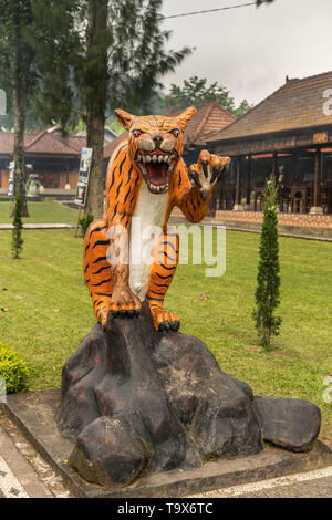 Bali, Indonesia - February 25, 2019: Ulun Danu Beratan Temple complex in Bedoegoel. Effigy of Tiger in park. Stock Photo