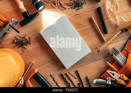 Instruction manual mock up on carpentry woodwork workshop desk, top view Stock Photo