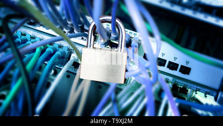 padlock on the cables at a network server, safety concept, color effect, selected focus, narrow depth of field Stock Photo