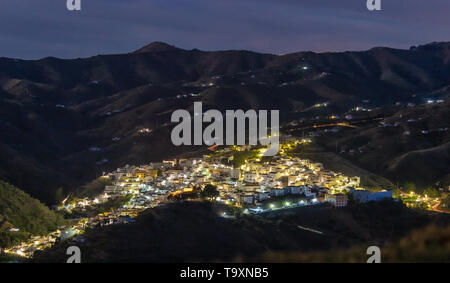 The town of Almáchar, in the province of Málaga, part of Andalusia in southern Spain, beautifully lit up ,shot at night from the mountains Stock Photo