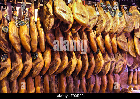 Palma Mallorca, Spain - March 20, 2019 : serrano and iberian iberico ham on display for sale in the local farmers indoor market stall Stock Photo