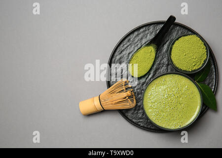 Composition with matcha tea on grey background Stock Photo