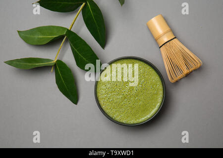 Composition with matcha tea on grey background Stock Photo