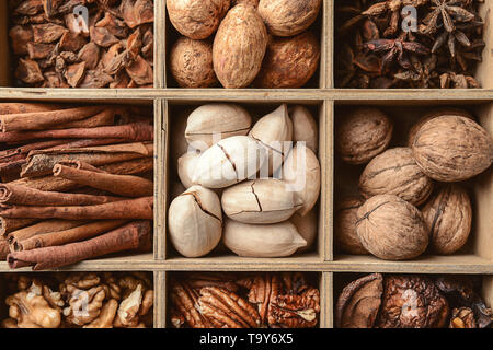 Assortment of nuts and spices in divided box, closeup Stock Photo