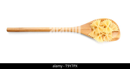 Spoon with uncooked farfalle pasta on white background Stock Photo