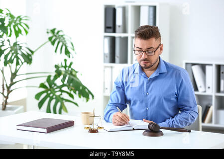 Handsome male lawyer working in office Stock Photo