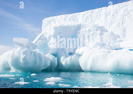 Closeup of light blue snowy iceberg floating in the aquamarine blue water of the Southern Atlantic Ocean near Antarctica. Stock Photo