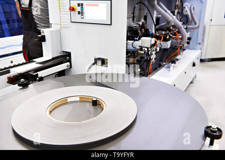 Single sided automatic edge banders on factory Stock Photo