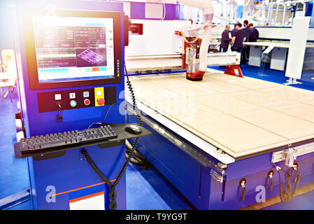 Milling and engraving CNC center with automatic tool change for furniture in the factory Stock Photo