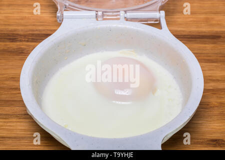 microwave two egg cooker with two cooked eggs Stock Photo - Alamy