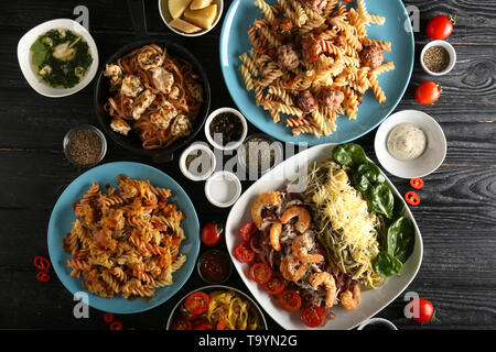 Plates with different pasta on table, top view Stock Photo