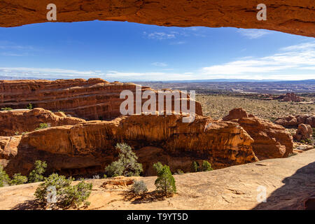 arch of rock with blue sky in the background Stock Photo