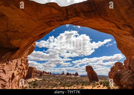 arch of rock with blue sky in the background Stock Photo