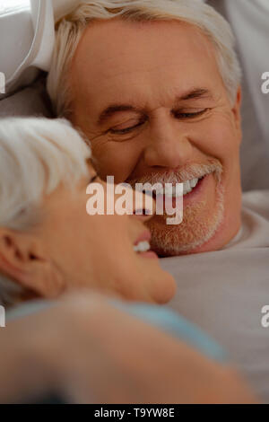 Face-portrait of white-haired vigorous man looking at silver-haired beautiful wife Stock Photo