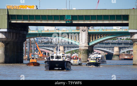 Boats operated by the Port of London Authority, Royal National Lifeboat Institution, Metropolitan Police and London Fire Brigade on the River Thames during the launch of a new campaign to help prevent accidents and self-harm incidents on the River Thames in London. Stock Photo