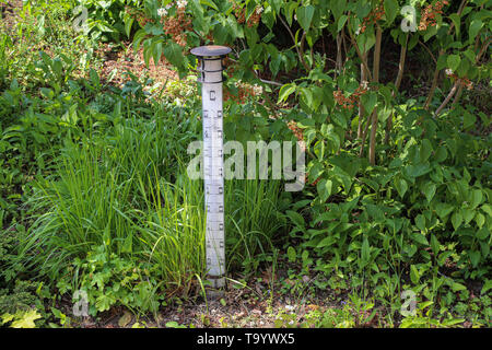 Large street thermometer stands in the garden. Stock Photo