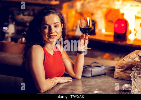 Woman drinking wine in the bar while waiting for man Stock Photo