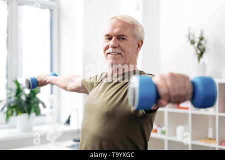 Nice active aged man practicing physical activities Stock Photo