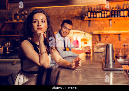 Dark-eyed woman waiting for her friend in the bar Stock Photo