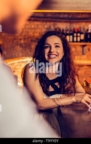 Woman feeling happy spending night in bar with her man Stock Photo