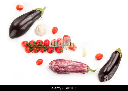 A flat lay composition with vegetables. Eggplants, tomatoes, and garlic, shot from above on a white background with copy space Stock Photo