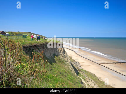 A view of people on the Paston Way footpath by the cliff top on the North Norfolk coast at Overstrand, Norfolk, England, United Kingdom, Europe. Stock Photo