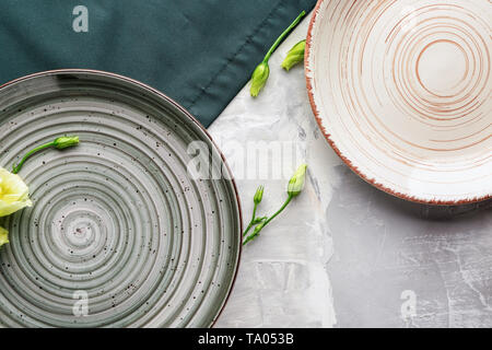 Stylish plates on grey background Stock Photo