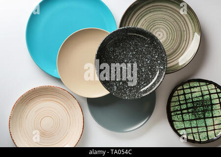 Set of stylish plates on light background Stock Photo