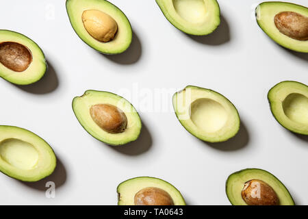 Plenty of fresh avocados on white background Stock Photo