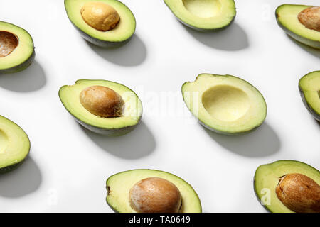 Plenty of fresh avocados on white background Stock Photo