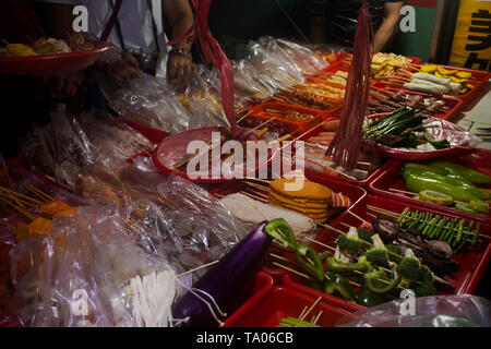 Chinese people and traveler foreigner order food and eating meat with Sichuan pepper grilled or BBQ with chinese seasoning at local restaurant on May  Stock Photo