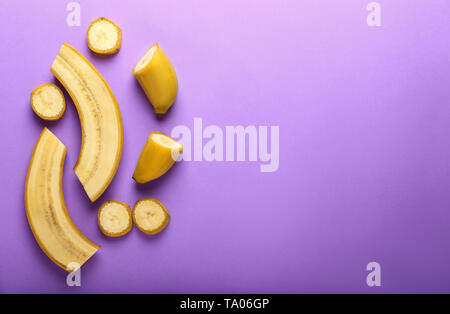 Tasty cut bananas on color background Stock Photo