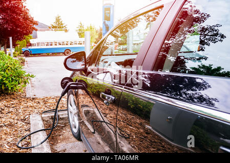 an electric vehicle connected to a battery charger in central london at